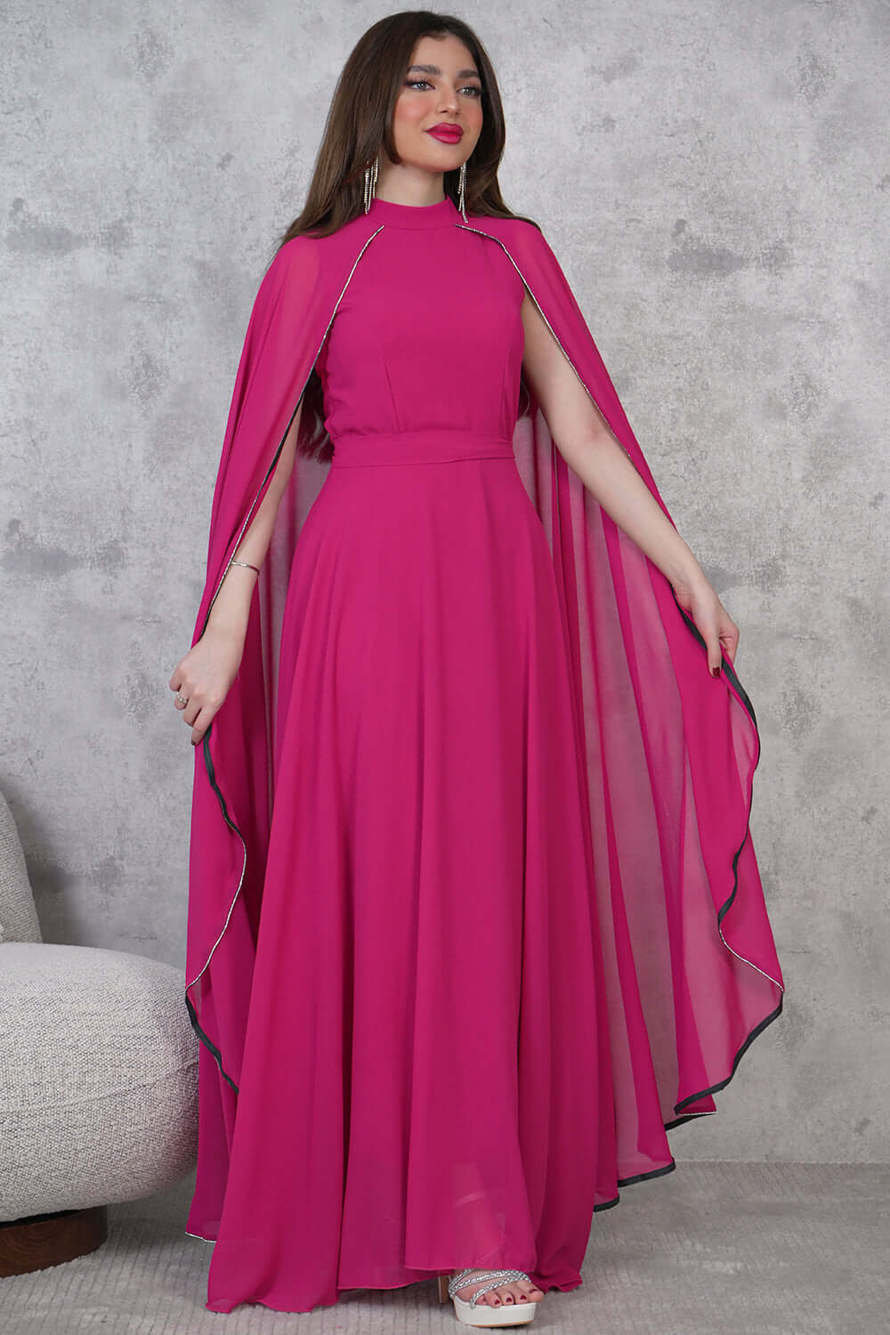 Elegant dress with a cape design decorated with beads 