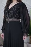 Black evening dress with embroidered piece and studs 