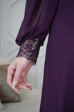 Evening dress decorated with an embroidered piece and purple stones 