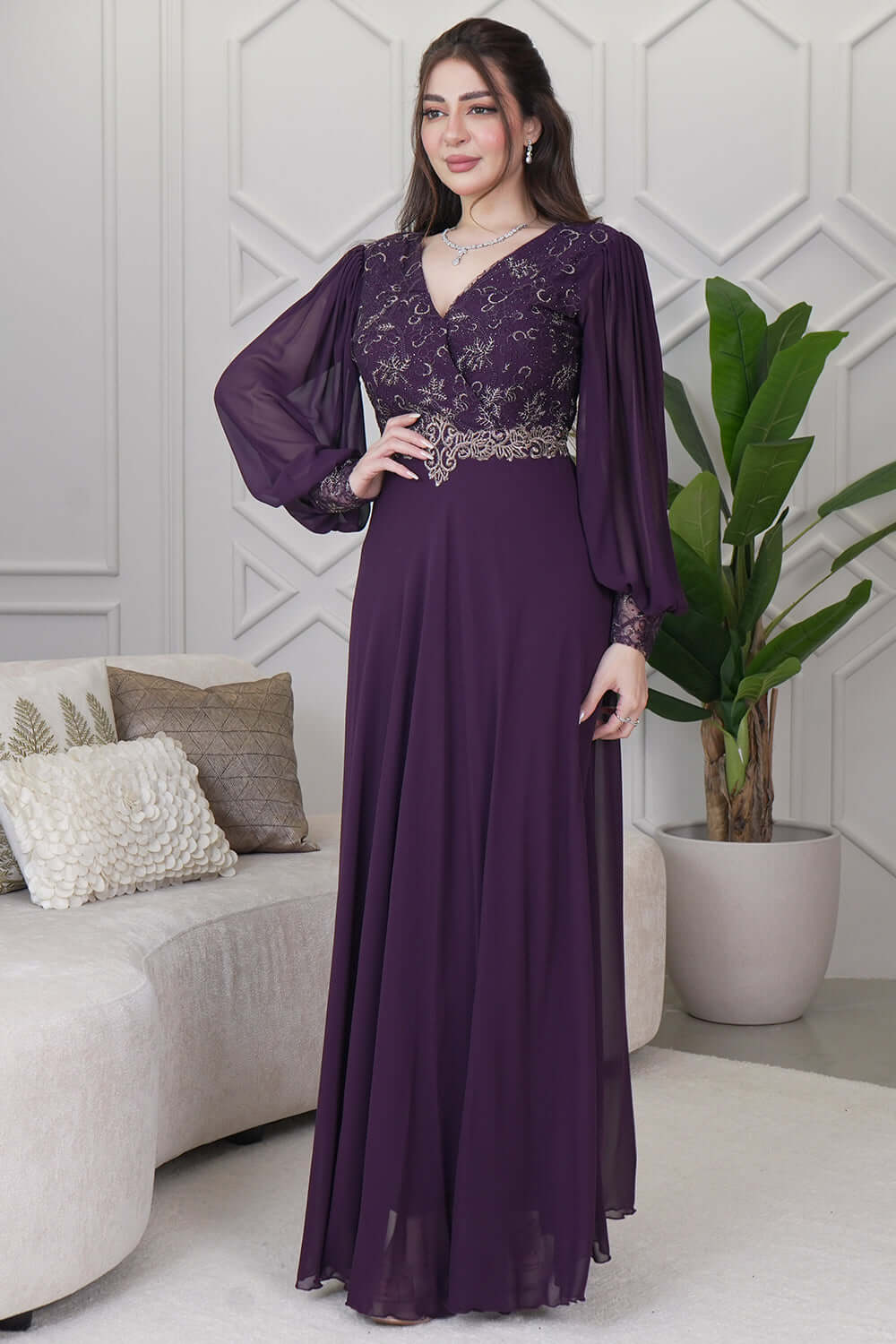 Evening dress decorated with an embroidered piece and purple stones 