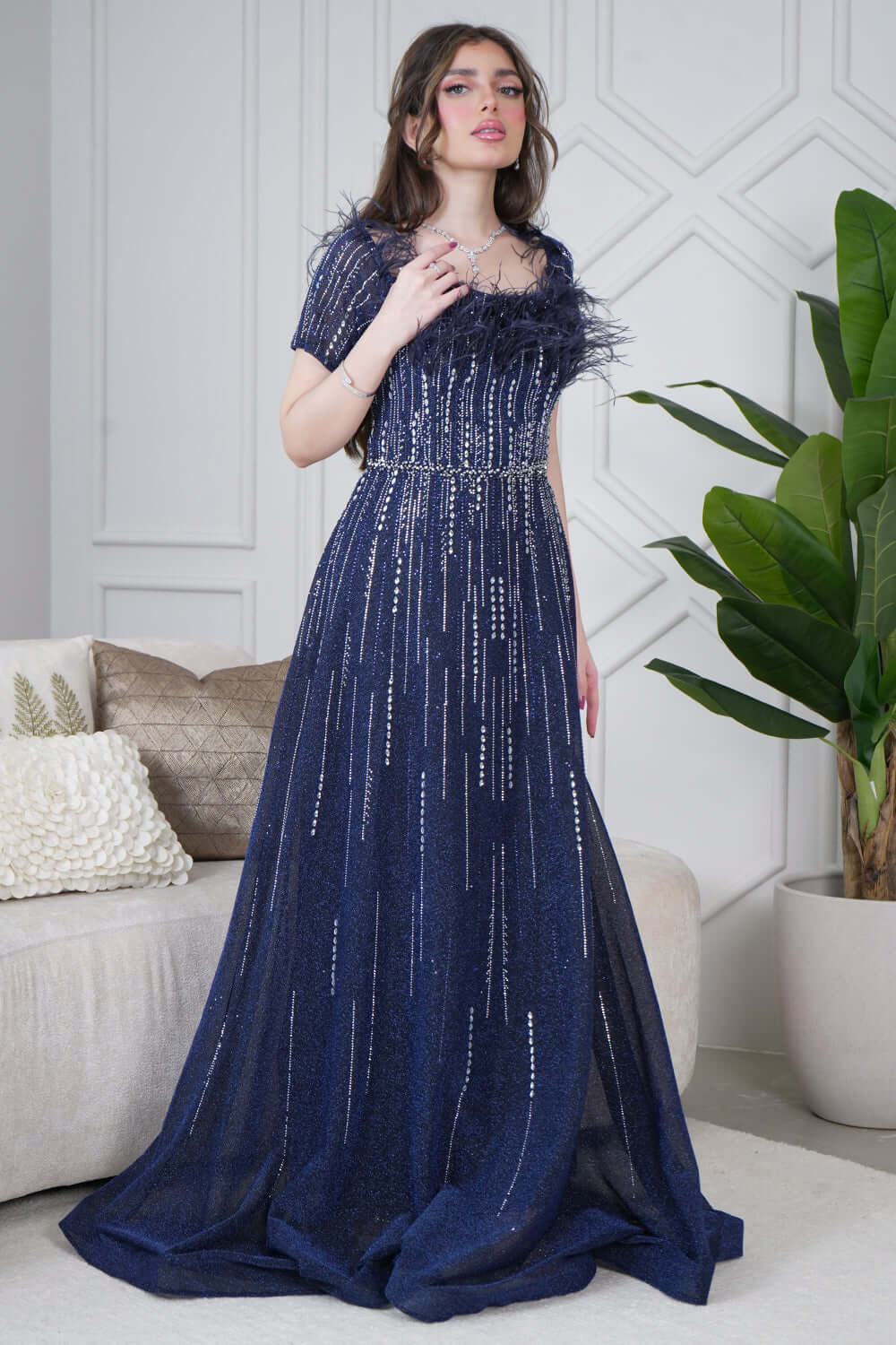 Long evening dress decorated with rhinestones and feathers in navy blue 