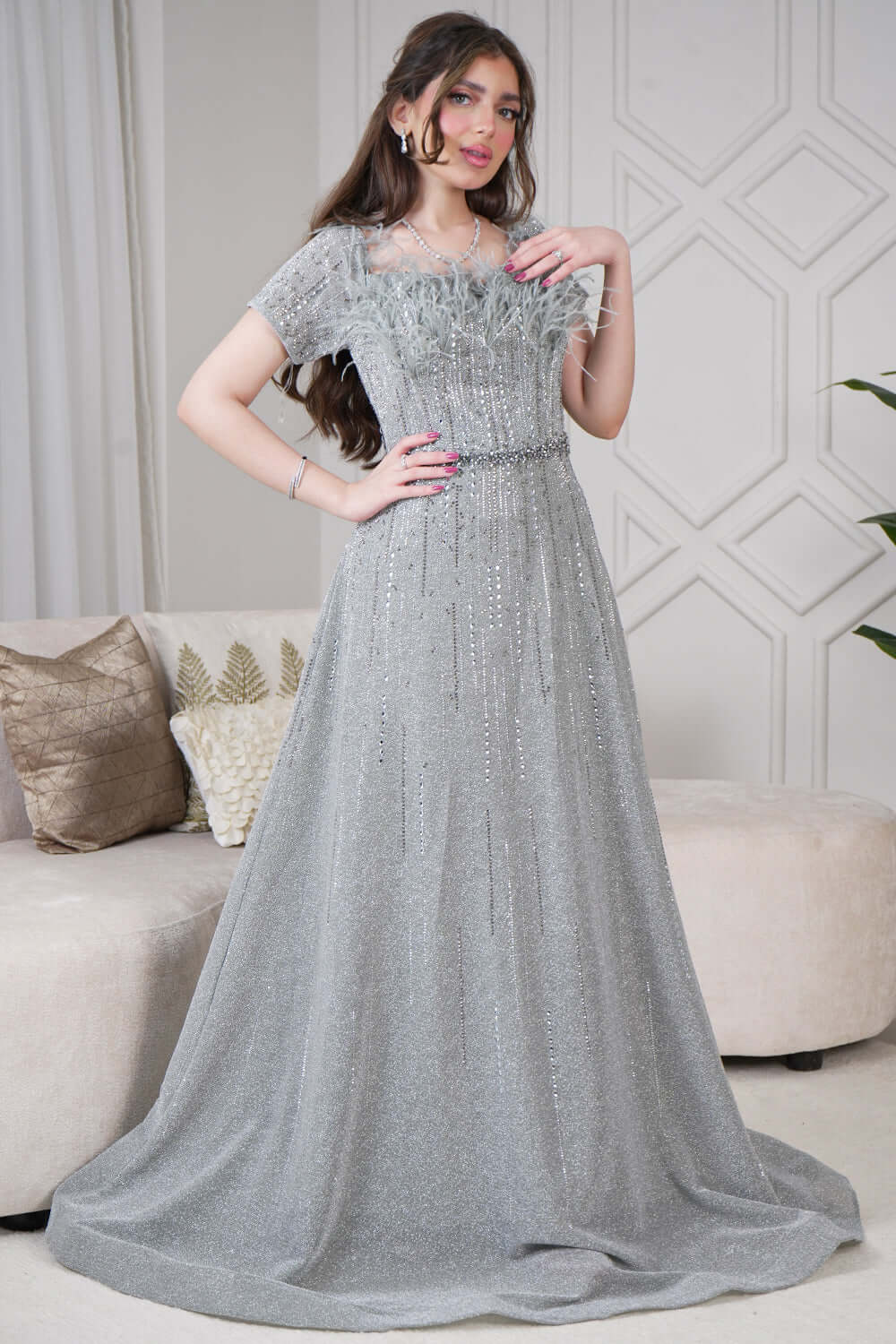 Long evening dress decorated with stones and feathers in gray color 