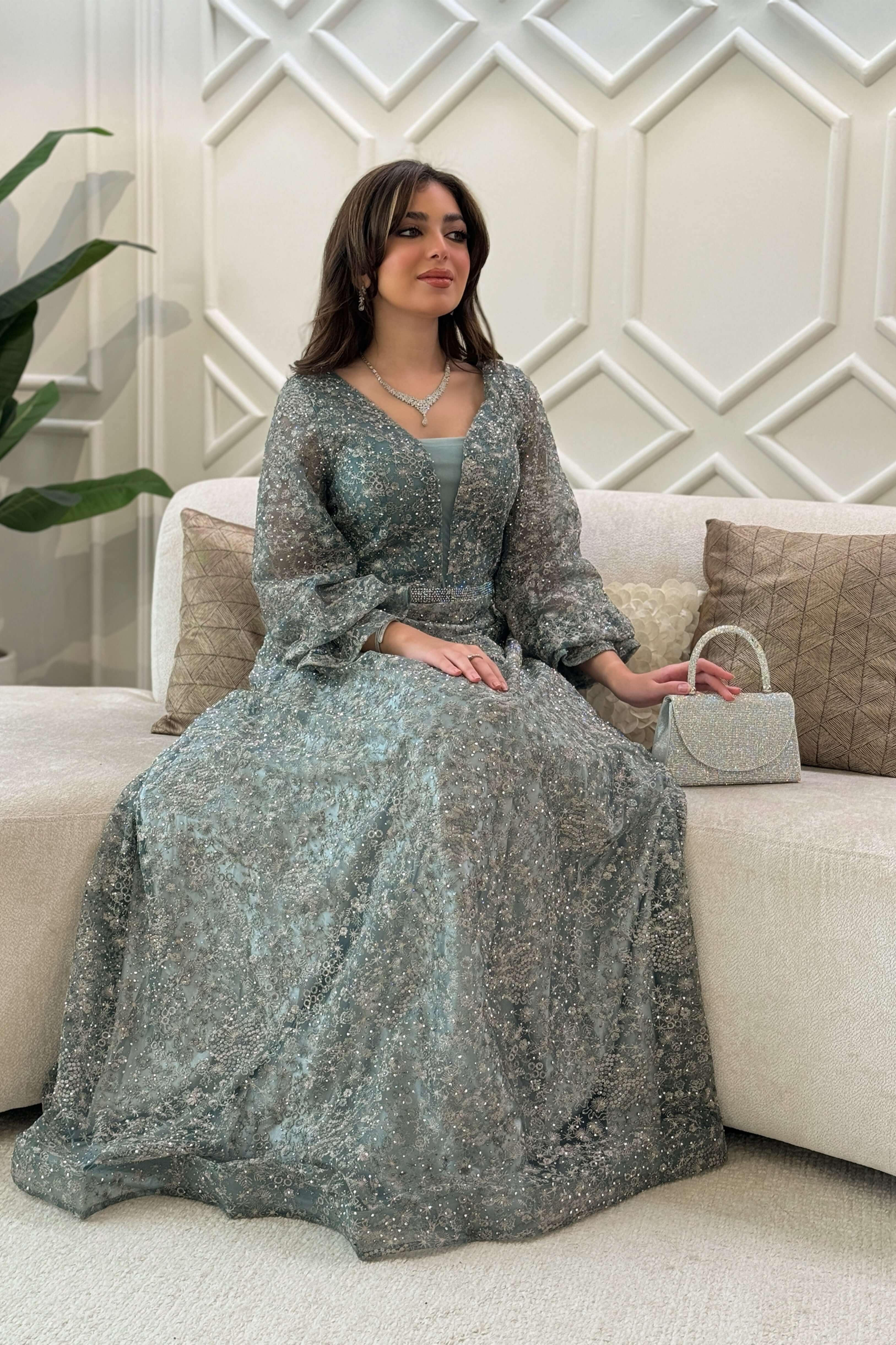 Long evening dress decorated with stones in light green 