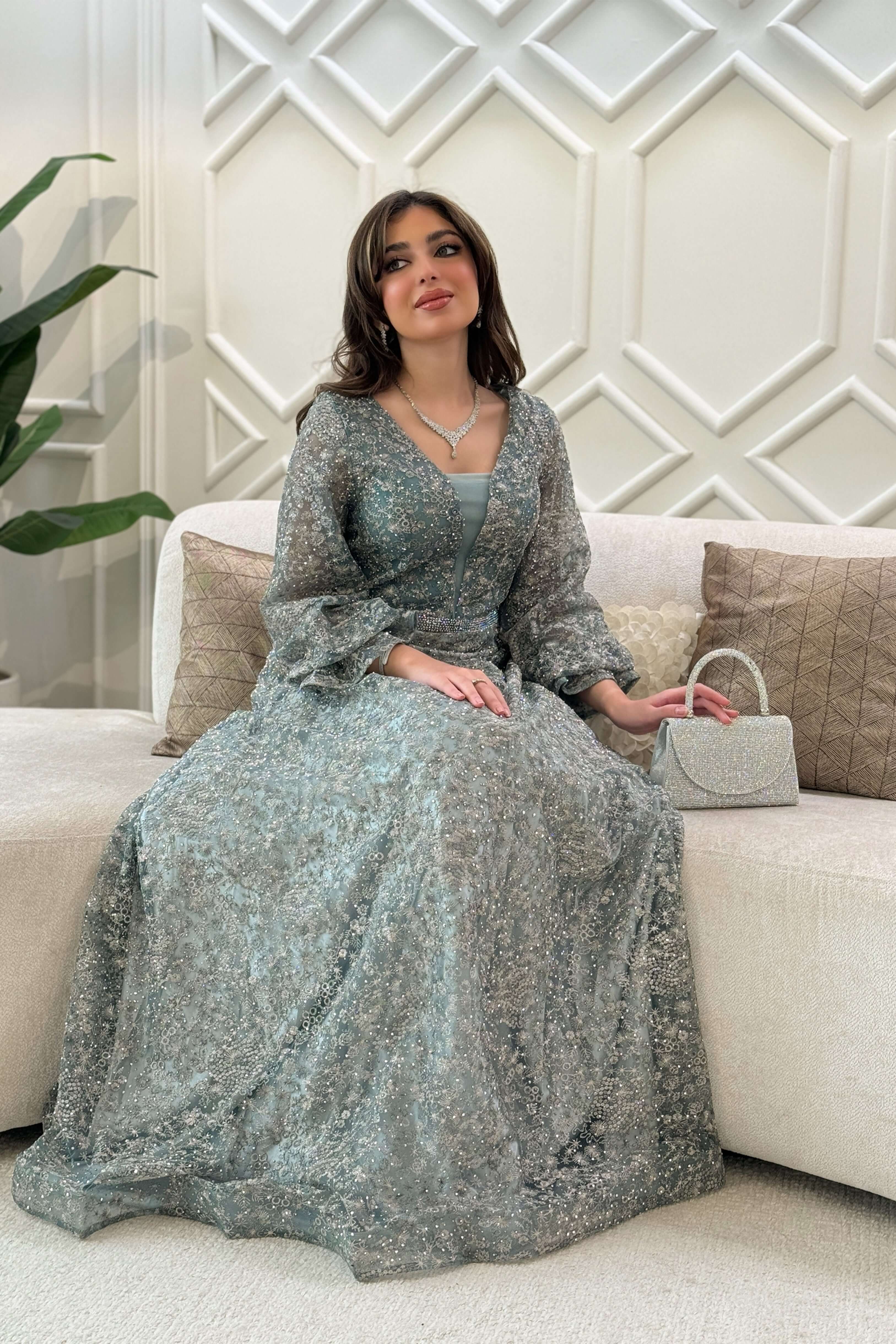 Long evening dress decorated with stones in light green 