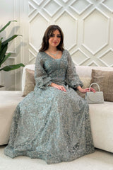 Long evening dress decorated with stones in light green 