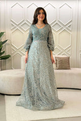 Long evening dress decorated with stones in light green 