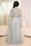 Tulle evening dress embroidered with a cape design 