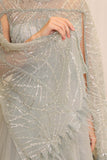 Tulle evening dress embroidered with a cape design 