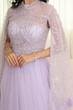 Tulle evening dress embroidered with a cape design 