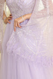 Tulle evening dress embroidered with a cape design 