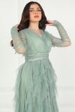 Evening dress with layers of ruffles and embroidered waist in pistachio color