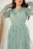 Evening dress with layers of ruffles and embroidered waist in pistachio color