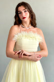 Yellow feather-decorated cloche top dress