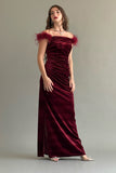 Off-the-shoulder velvet dress decorated with burgundy feathers