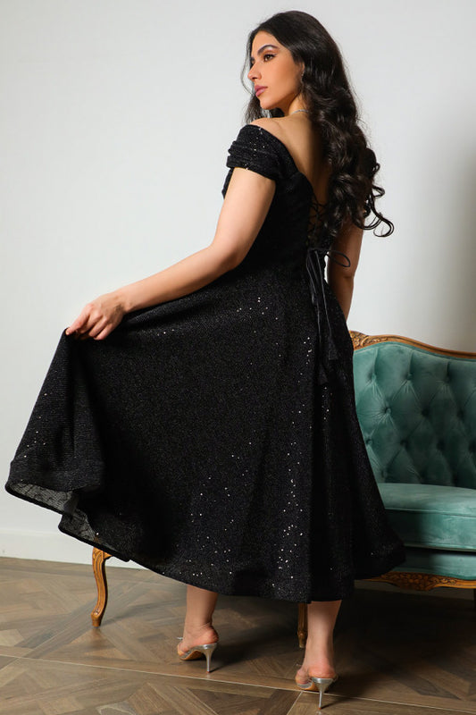 Mid-length evening dress decorated with black sequins
