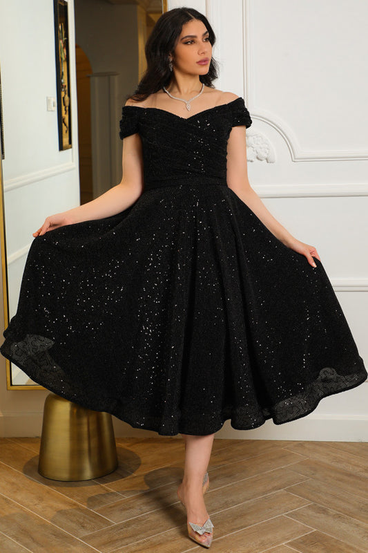 Mid-length evening dress decorated with black sequins