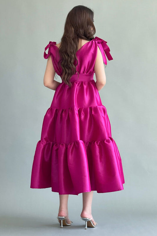 Mid-length dress with layers and a bow on the shoulder, fuchsia color