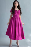 Off-shoulder evening dress with a fuchsia bow