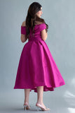 Off-shoulder evening dress with a fuchsia bow