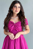 Off-shoulder evening dress with a fuchsia bow