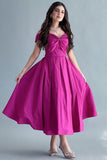 Off-shoulder evening dress with a fuchsia bow