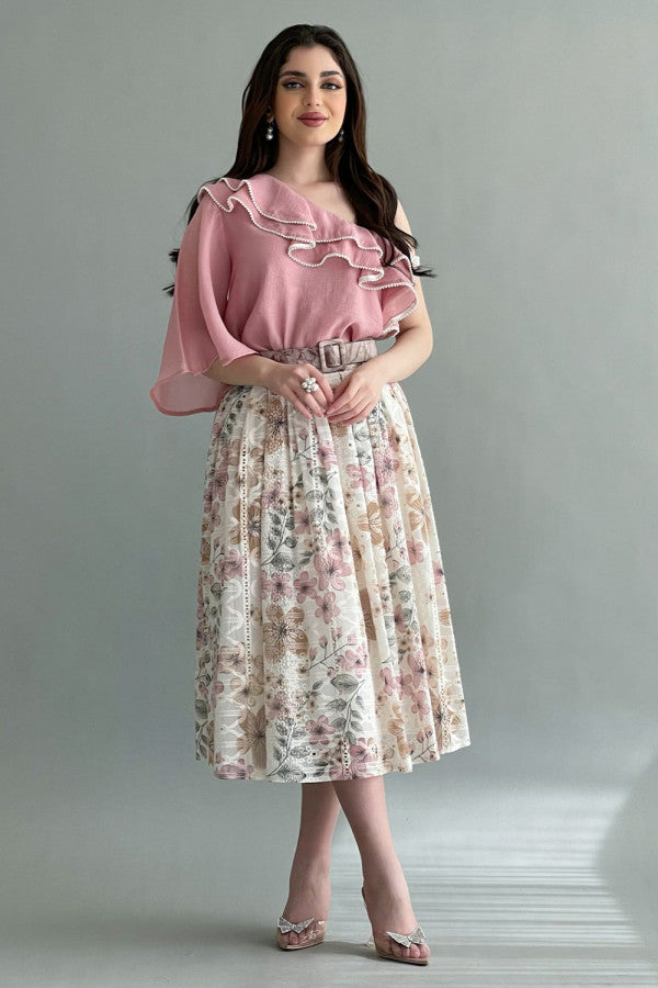 A floral skirt and one-shoulder blouse with ruffles