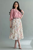 A floral skirt and one-shoulder blouse with ruffles