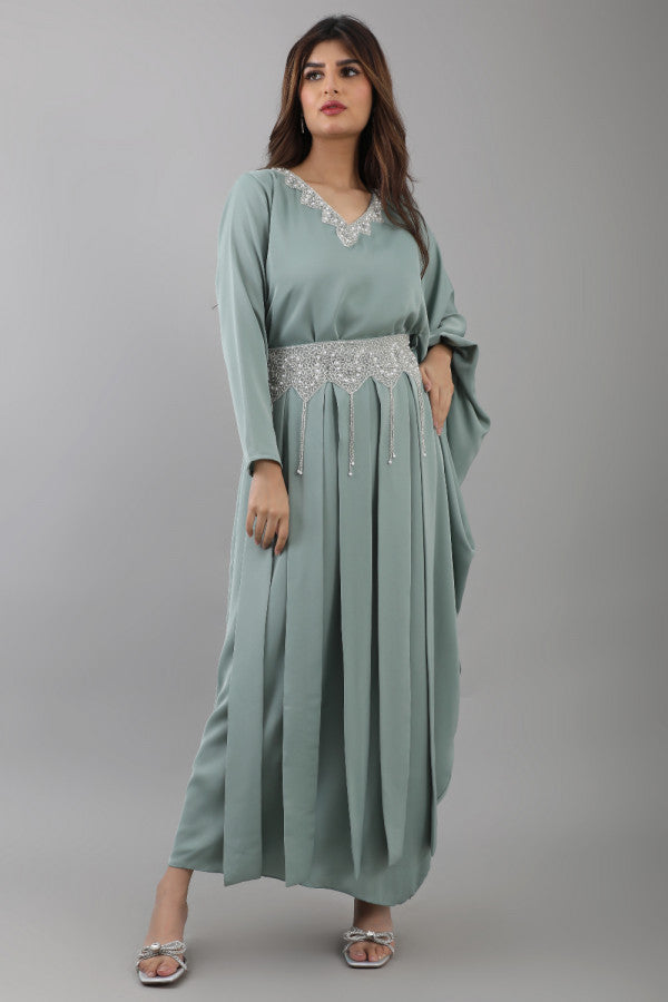 A modern jalabiya with a distinctive design, embroidered with beads and Tiffany color