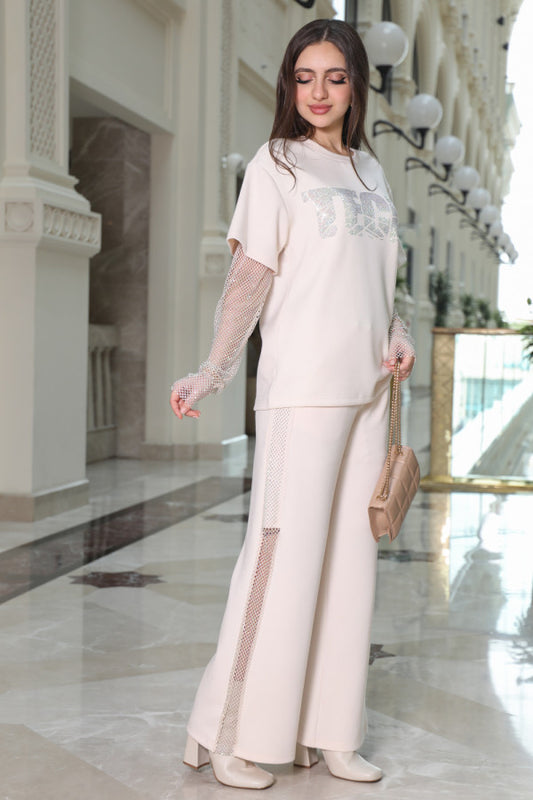 A set of trousers and a blouse decorated with a sugar-colored mesh 