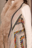 A beige fur-trimmed sweater coat with a colorful pattern 