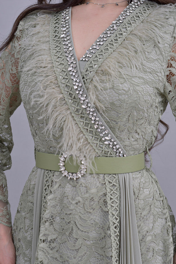 Green lace dress decorated with crystals and feathers