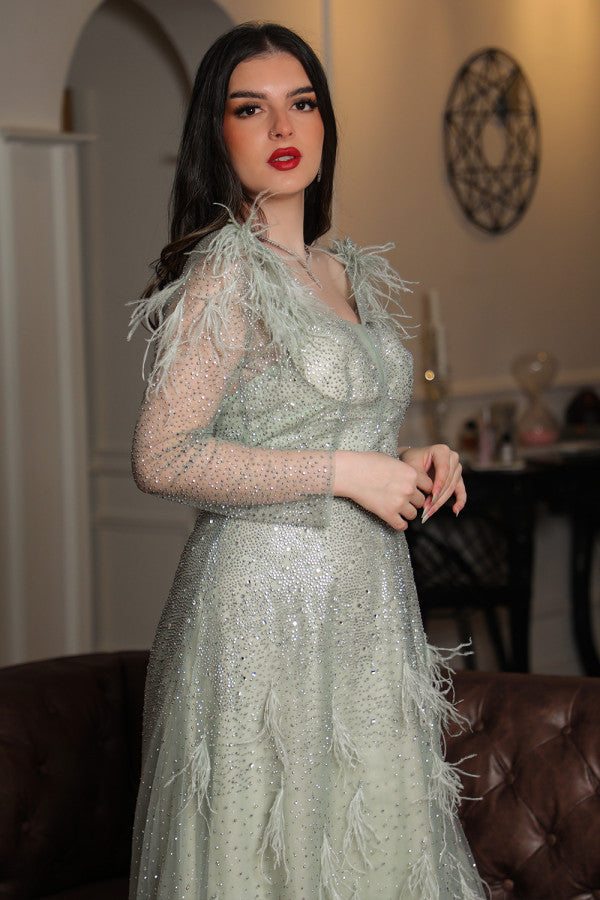 Light green feather-embellished off-shoulder evening dress