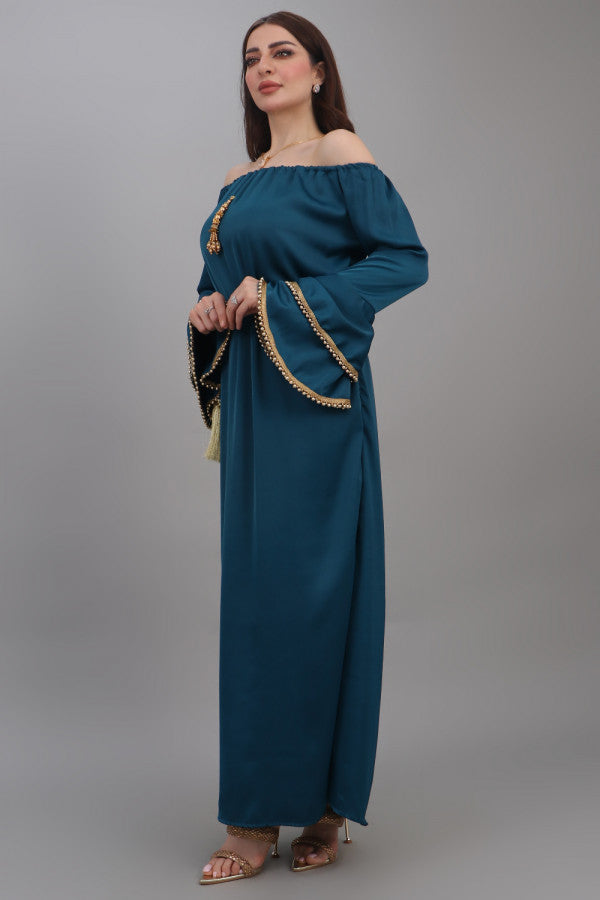 A soft oriental robe with ruffles sleeves decorated with golden crystals, turquoise colour