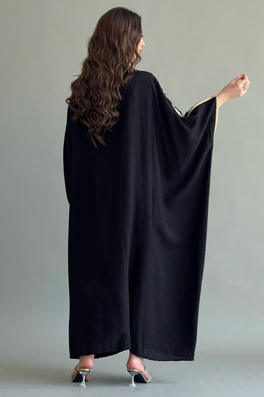 A two-piece plain galabiya with a bisht embroidered with gold threads, black colour