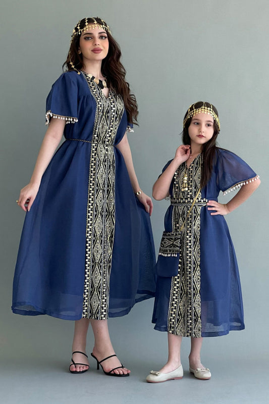 Kuwaiti girls' jalabiya with vertical embroidery and decorated with blue tassels 