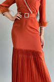 Pleated satin dress with crystal ribbon and brick-colored feathers