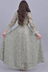 Green lace dress decorated with crystals and feathers