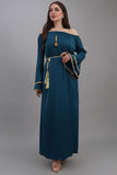 A soft oriental robe with ruffles sleeves decorated with golden crystals, turquoise colour