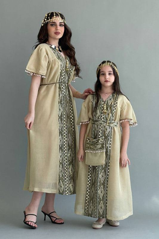Kuwaiti girls' jalabiya with vertical embroidery and decorated with Lulu tassels, beige colour