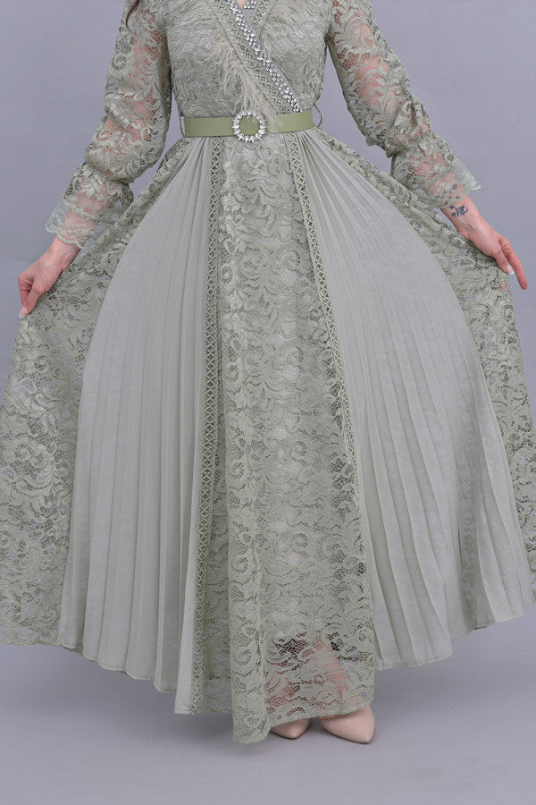Green lace dress decorated with crystals and feathers