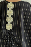 A black and white striped bisht galabiya decorated with a golden qitan 