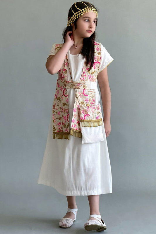 A Kuwaiti girls' jalabiya with a flowing shawl, embroidered and decorated with tassels, in beige colour 