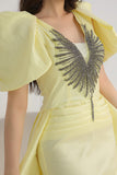 Yellow evening dress with embroidered chest and tail