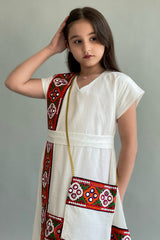 A soft girls' galabiya embroidered with burgundy Sadu 