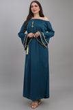 A soft oriental robe with ruffles sleeves decorated with golden crystals, turquoise colour