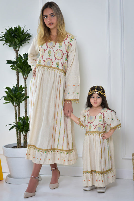 Girls' galabiya with embroidered lines and colorful patterns, decorated with beads and lullabies 