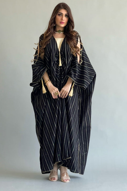 A black and white striped bisht galabiya decorated with a golden qitan 