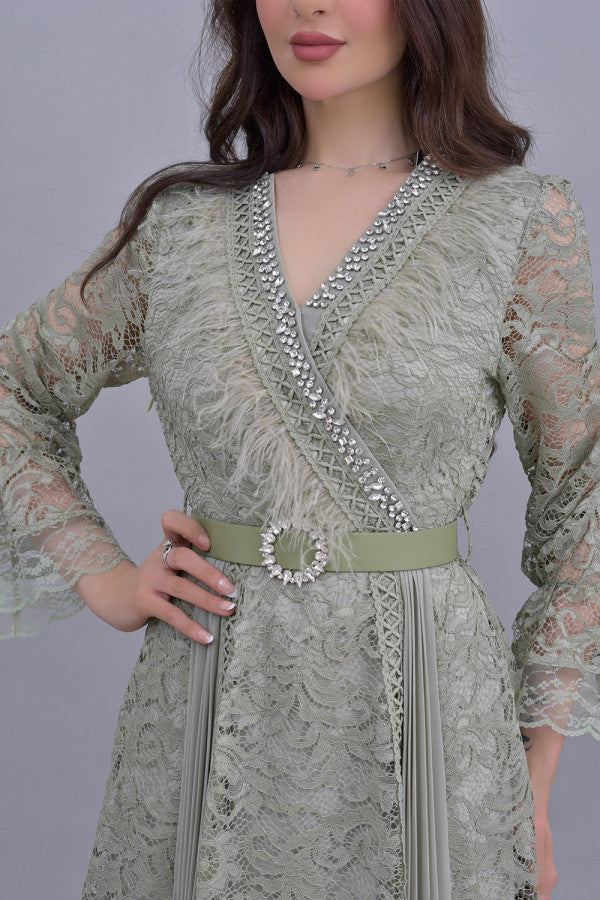 Green lace dress decorated with crystals and feathers