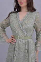 Green lace dress decorated with crystals and feathers