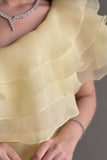 Yellow one-shoulder cloche dress with layers of ruffles